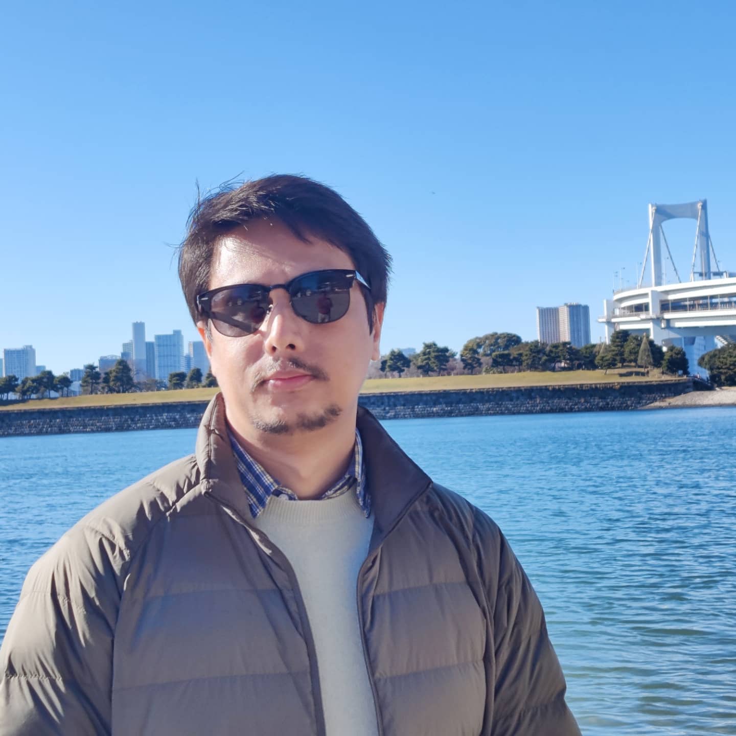 Kishor Timsina outdoors by the waterfront